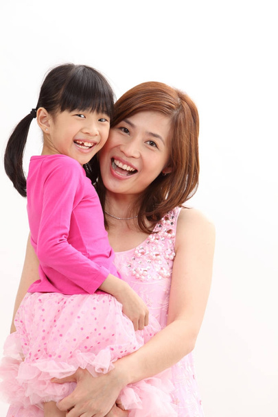 studio shot of mother and daughter hugging - Photo, Image