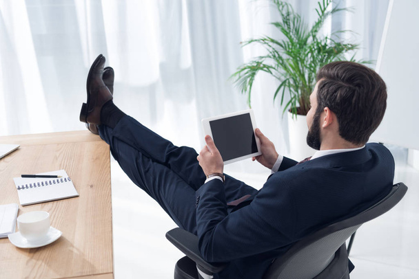 side view of businessman using tablet at workplace in office - Foto, Imagem