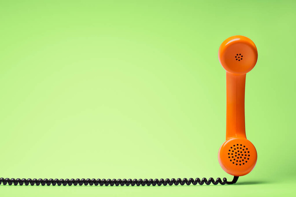 Telephone in retro style on green background. - Photo, image