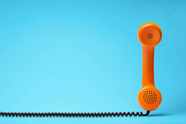 Telephone in retro style on blue background. - Foto, imagen