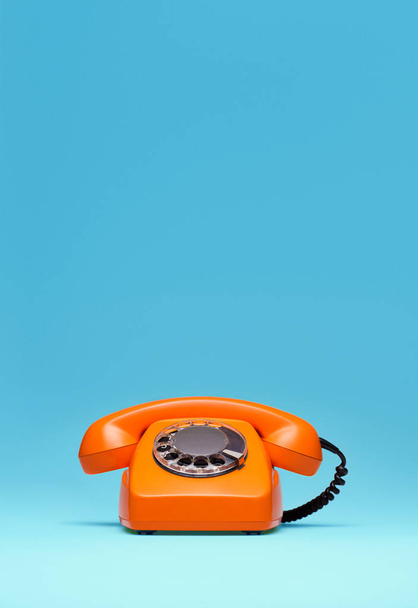 Telephone in retro style on blue background. - Photo, image