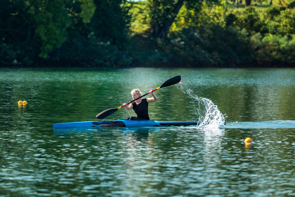 Hembra atleta entrenamiento kayak en el lago
 - Foto, imagen