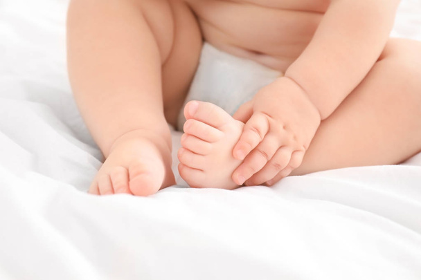 Little baby sitting on bed, closeup - Photo, Image