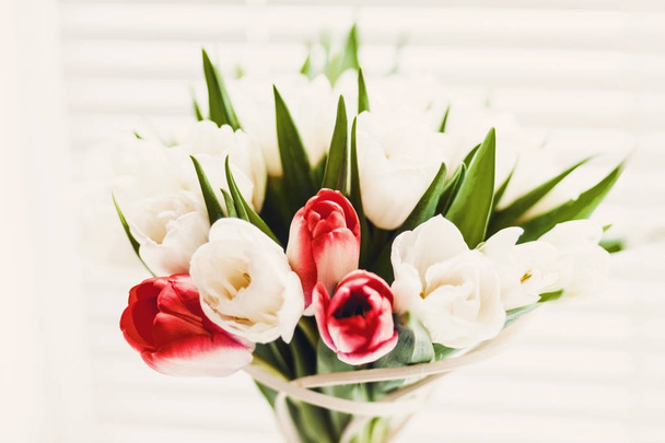 Bouquet of red and white tulips in vase isolated on white background. Horizontal view - Φωτογραφία, εικόνα