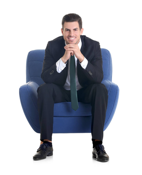 man sitting in armchair  - Фото, зображення