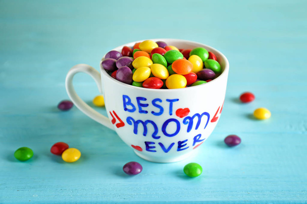 Cup with text BEST MOM EVER and candies  for Mother's day on table - Fotografie, Obrázek