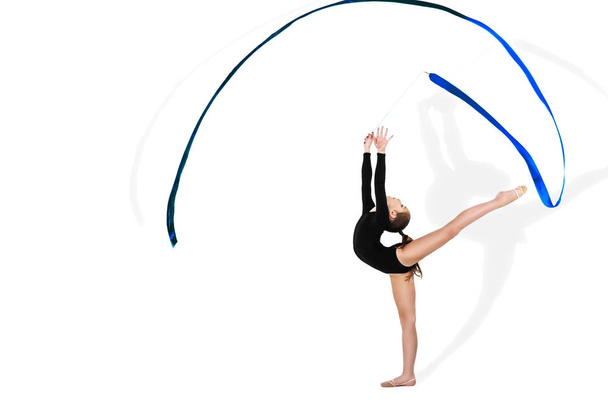 Yong gymnast performing exercise with ribbon on isolated background - Photo, Image