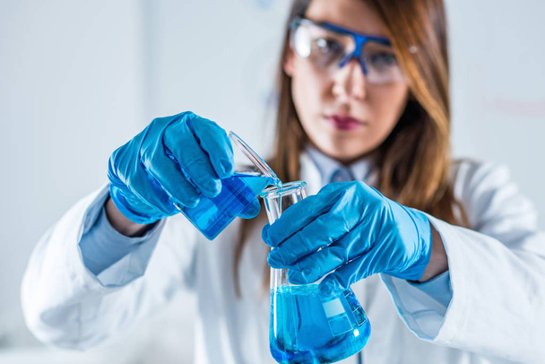 Biotechnology. Female scientist working in laboratory - Photo, image