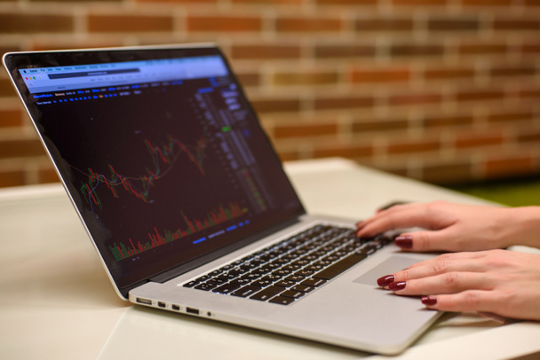 Девушка с ноутбуком смотрит биткоины графики и акции
 - Фото, изображение
