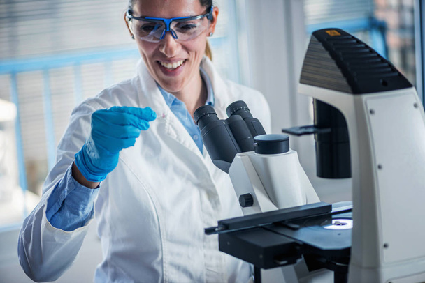 Science researcher working in laboratory - Photo, Image