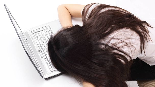 closeup.a young employee falling asleep on the laptop keyboard - Fotografie, Obrázek