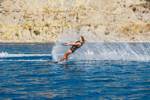 Water skis glides on the waves, female athlete on Aegean Sea, Greece - Photo, Image
