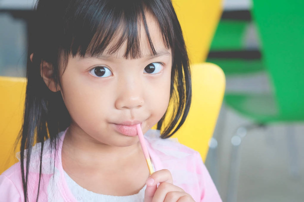 Asian child girl happy eating snack crispy crunches - Photo, Image