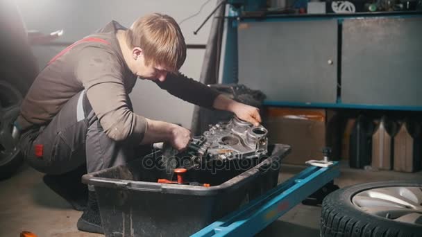 Mechanic cleans the engine parts, wiping, profile view - Footage, Video