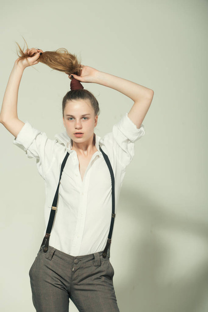 Girl in fashionable pants, suspenders and shirt. - Valokuva, kuva