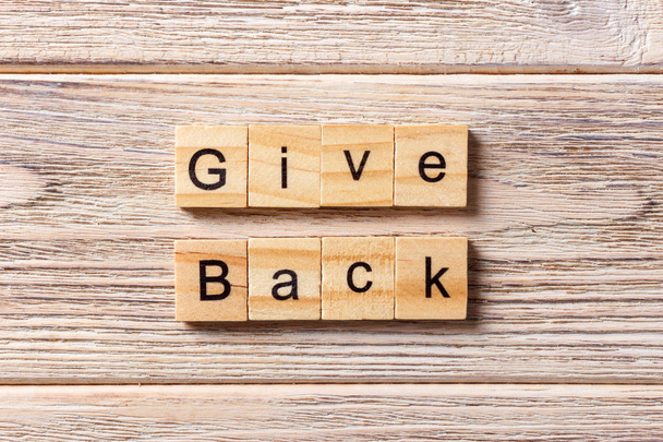 Give Back word written on wood block. Give Back text on table, concept - Photo, Image