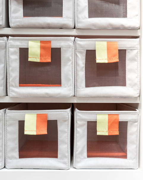 Fabric storage boxes in square shape with orange and yellow pull - Photo, Image