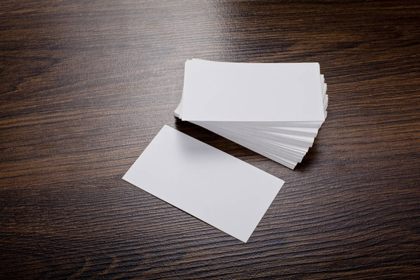 Mockup of white business cards at wooden background - Foto, afbeelding