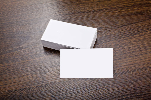 Mockup of white business cards at wooden background - Foto, Imagen