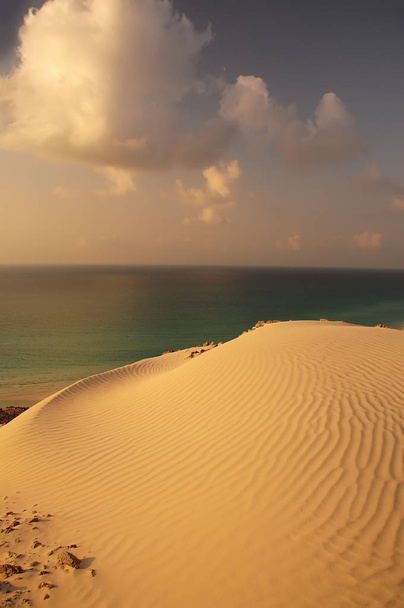 beautiful view of the sunset at the sea with a sand dune. Sea calm sunset view. - Fotoğraf, Görsel