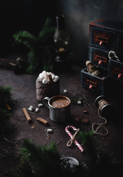 close-up of hot chocolate with marshmallows on wooden table with Christmas decoration and fir tree branches - Foto, Imagen