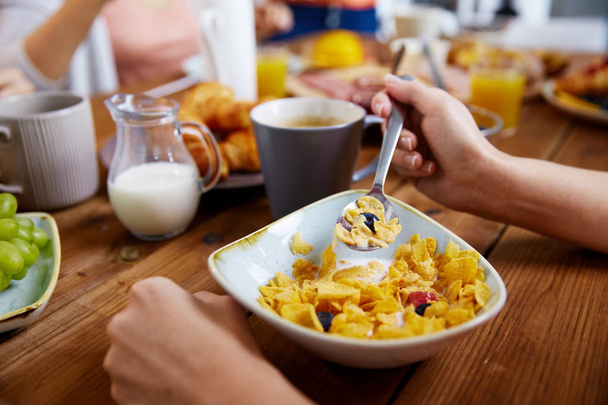 hands of woman eating cereals for breakfast - Foto, Imagen