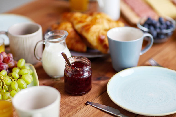 jar with jam on wooden table at breakfast - Photo, image