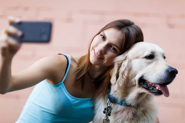 Photo of woman doing selfie with dog - Zdjęcie, obraz
