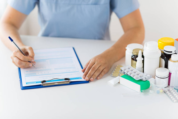 doctor with medicines and clipboard at hospital - 写真・画像