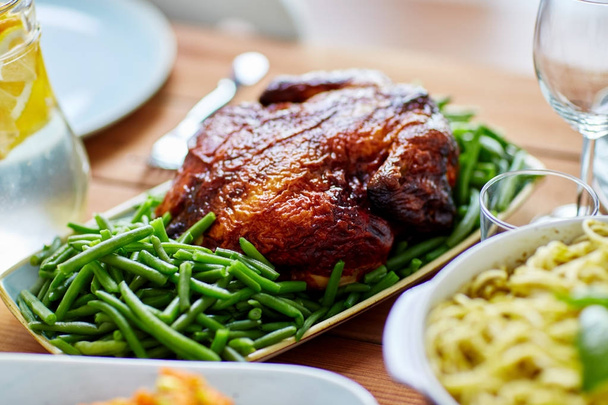 roast chicken with garnish of green peas on table - Fotografie, Obrázek