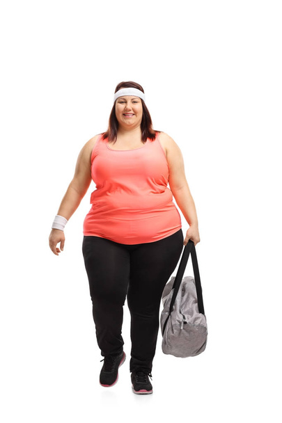 Overweight woman with a sports bag walking  - Photo, image