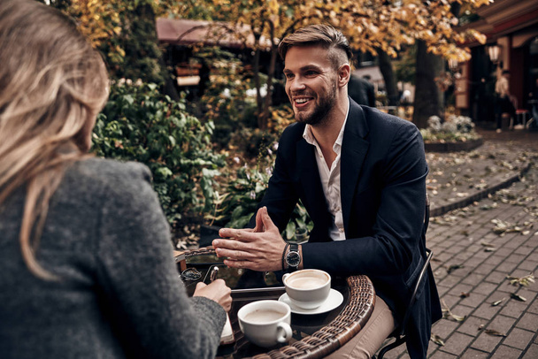 Handsome young man having a conversation with woman in restaurant, Job interview - Фото, изображение