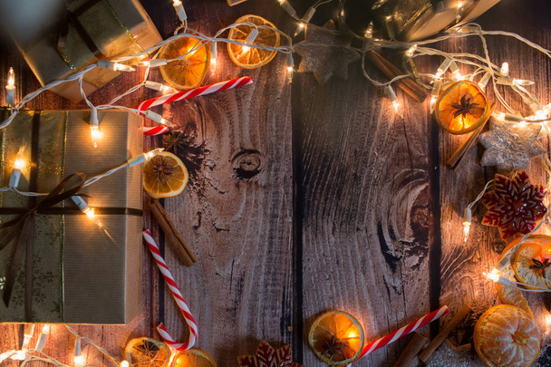 Christmas frame with lights, ornaments, candy and decorations. Free space - 写真・画像