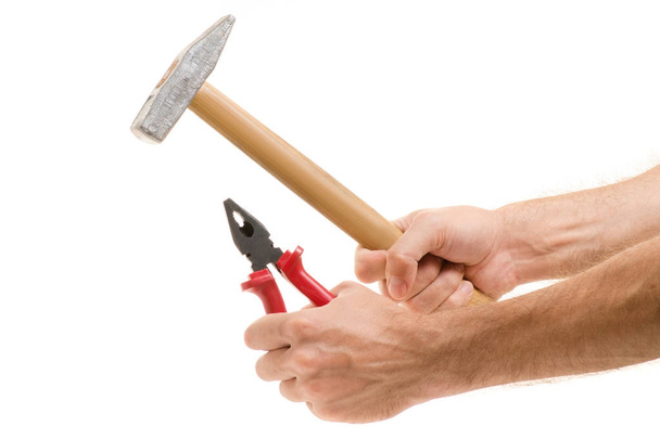 Hammer and pliers in the hands - Foto, afbeelding
