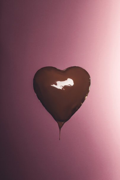heart shaped candy with liquid chocolate isolated on pink  - Photo, Image