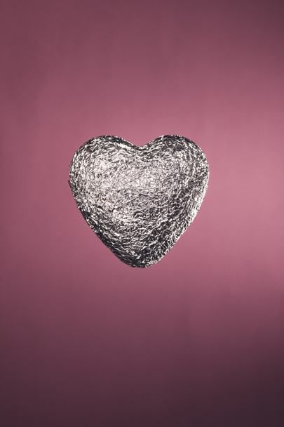 heart shaped candy in silver wrapper isolated on pink - Fotografie, Obrázek