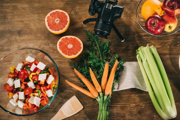 vista superior de cámara digital y verduras con frutas en mesa de madera
 - Foto, Imagen