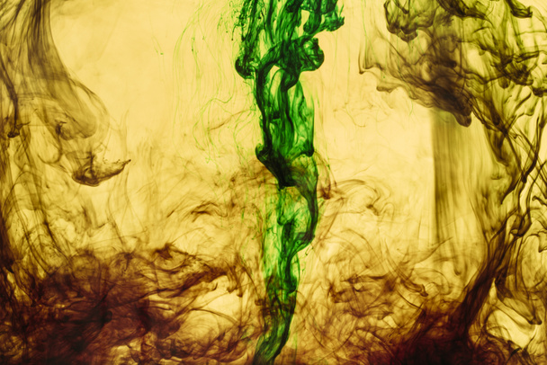 full frame of yellow and green paint splashes and swirls - Fotó, kép