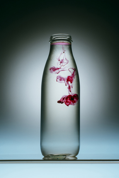 vista de cerca de salpicaduras de pintura rosa en botella de agua
 - Foto, Imagen