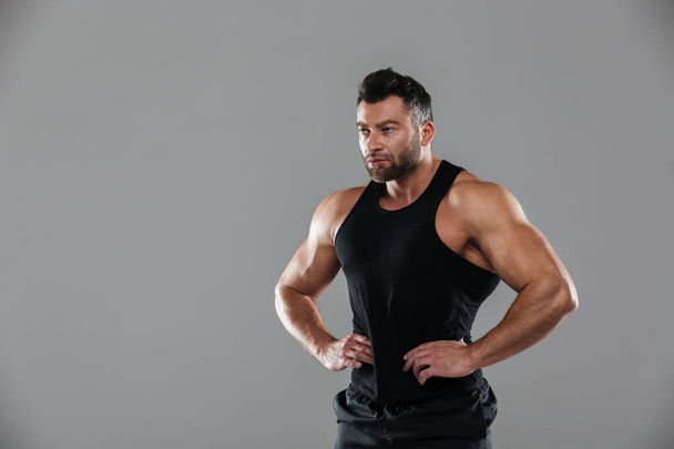 Portrait of a muscular serious male bodybuilder - Photo, image