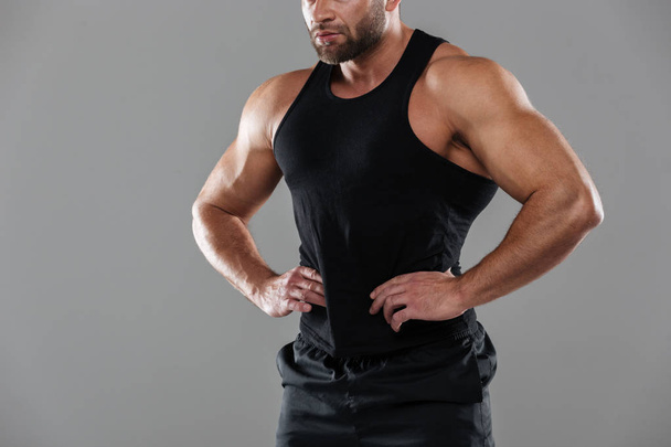 Cropped image of a muscular strong male bodybuilder - Foto, afbeelding