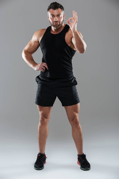 Full length portrait of a concentrated strong male bodybuilder - Fotografie, Obrázek