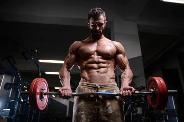 sexy strong bodybuilder athletic men pumping up muscles with dum - Fotoğraf, Görsel