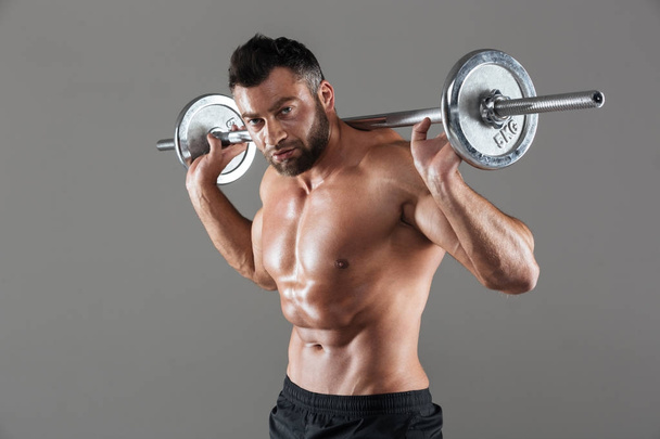 Portrait of a concentrated strong shirtless male bodybuilder - Fotografie, Obrázek