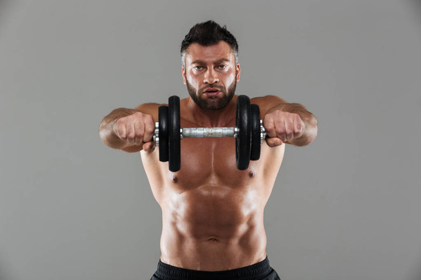 Portrait of a concentrated strong shirtless male bodybuilder - Fotografie, Obrázek