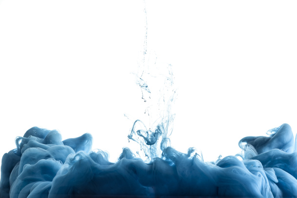 close up view of blue paint splash in water, isolated on white with copy space - Photo, Image