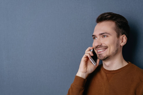 Young smiling man talking on mobile - Photo, image