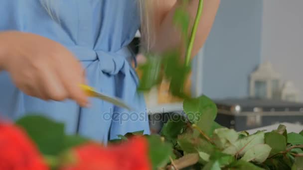 Professional florist working with flowers at studio - Felvétel, videó