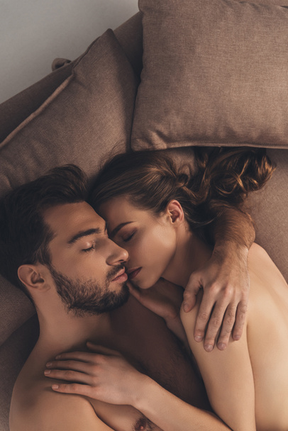 beautiful sexy young naked couple sleeping together in bed   - Fotografie, Obrázek