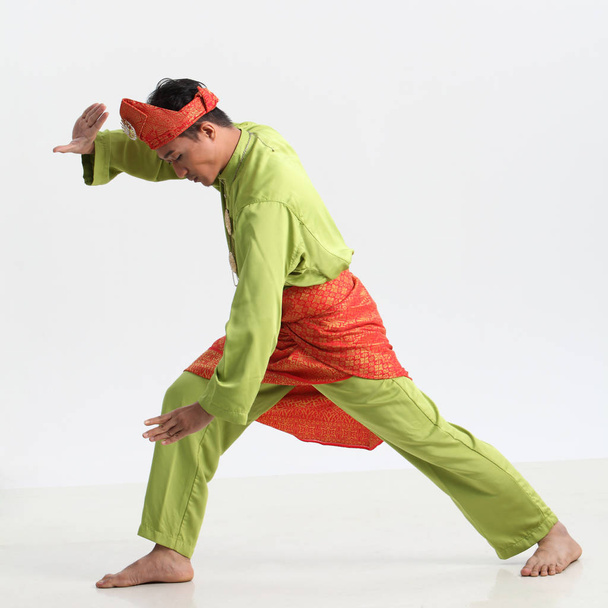 malay male performing martial art in studio - 写真・画像